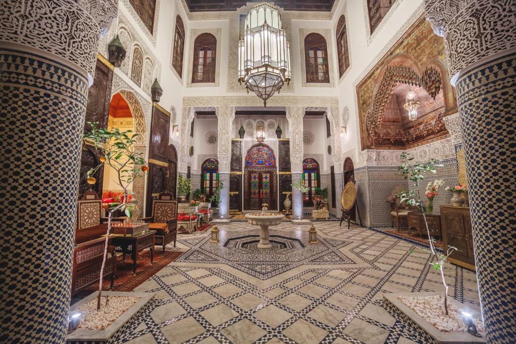 a large room with a fountain in the middle of a building at Riad Fes Maya Suite & Spa in Fez