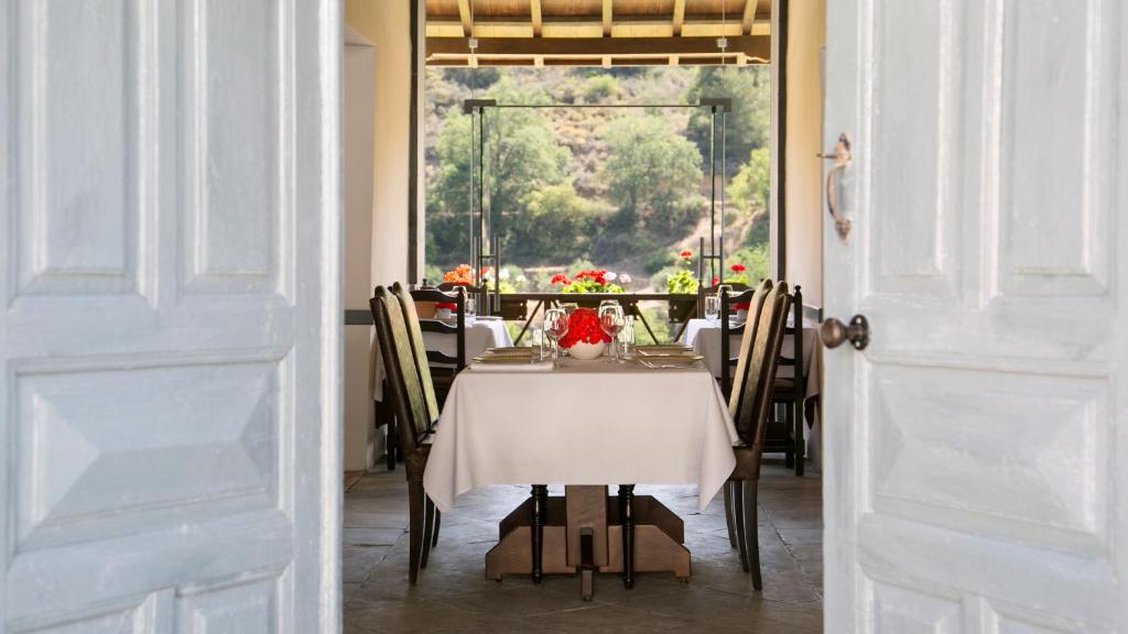 a dining room with a table with a white table cloth at Casale Panayiotis in Kalopanayiotis