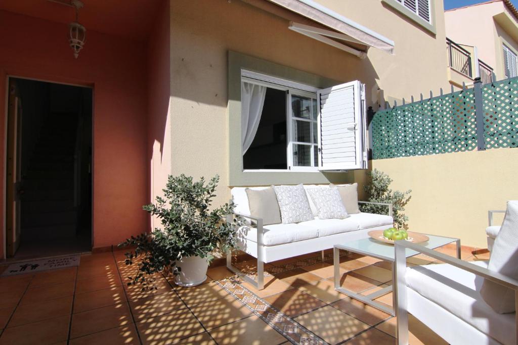 a patio with a couch and a table on a balcony at Las Velas 16 in Maspalomas