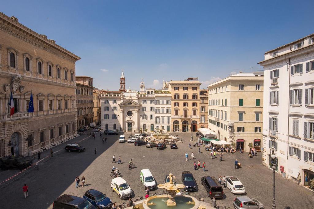 a city street with cars parked in a parking lot at Piazza Farnese exclusive view 2 bedroom en suite in Rome