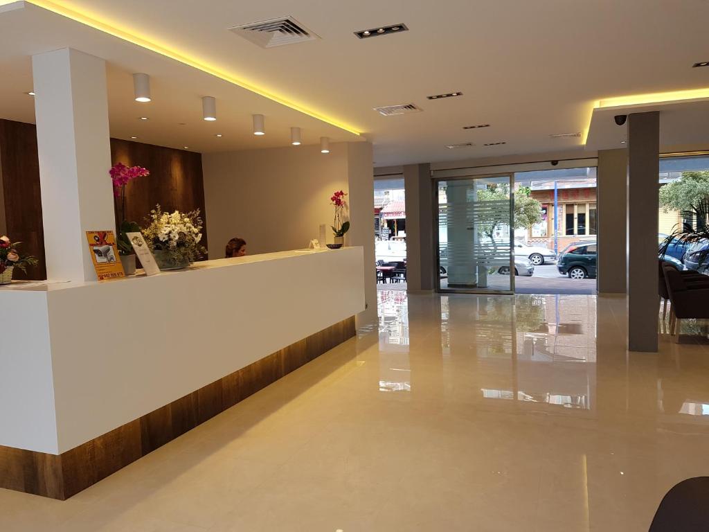 a lobby with a reception desk in a building at Hotel Perla in Benidorm