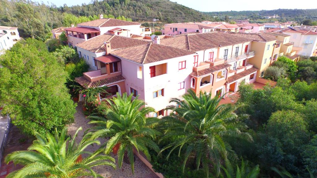 an aerial view of a town with palm trees and houses at Residence Sos Alinos in Cala Liberotto
