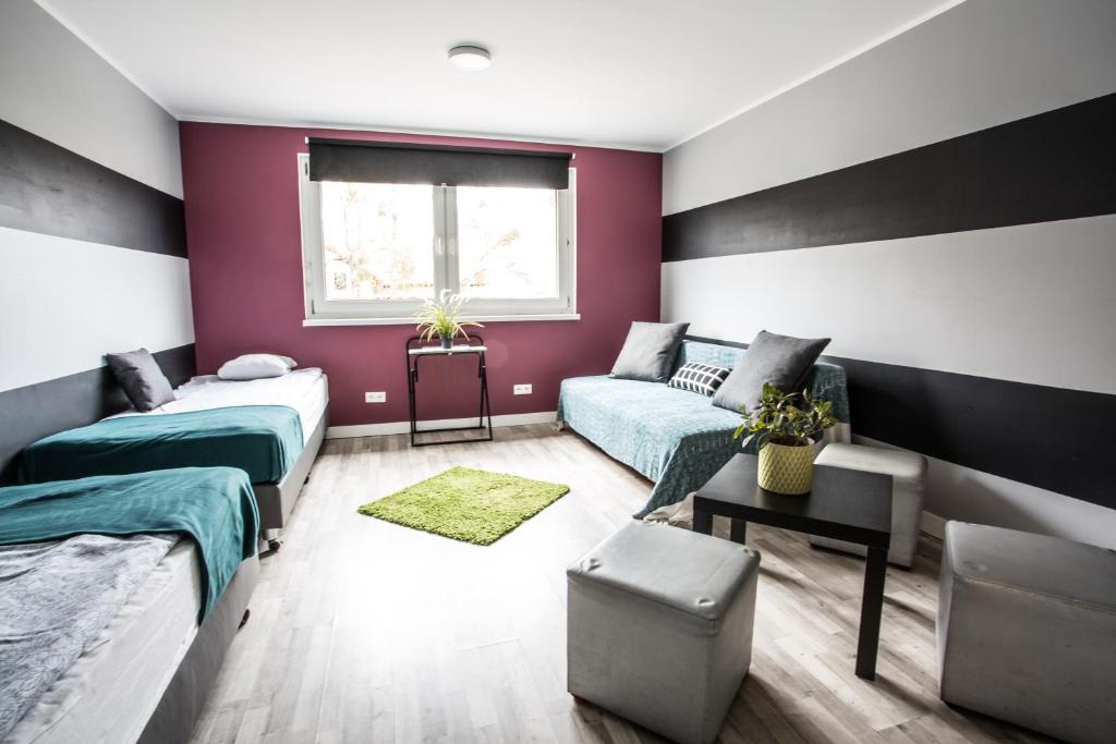 sypialnia z 2 łóżkami i kanapą w obiekcie Tetris Sopot w mieście Sopot