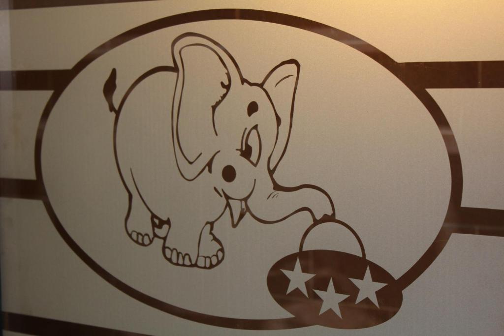 a sticker of an elephant and a baby elephant holding a ball at L'elefante in Catania