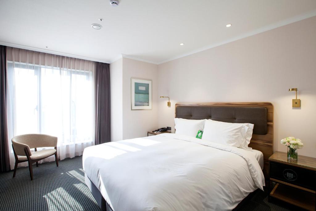 Postel nebo postele na pokoji v ubytování G2 Hotel Myeongdong