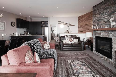 a living room with a couch and a fireplace at Apartment K2 07 in Mount Buller