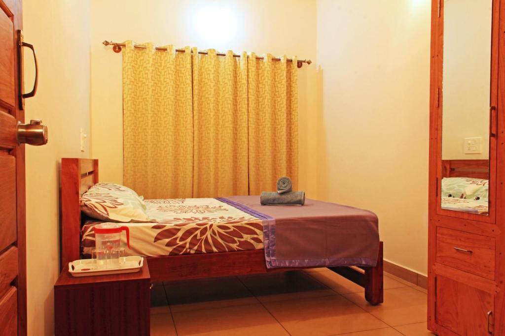 Ένα ή περισσότερα κρεβάτια σε δωμάτιο στο Coorg Rahul Villa- 3 Deluxe Bedrooms