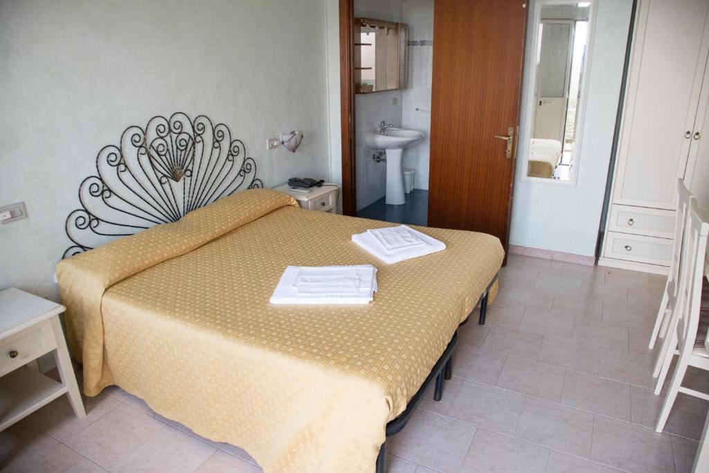 Postel nebo postele na pokoji v ubytování Hotel Paola