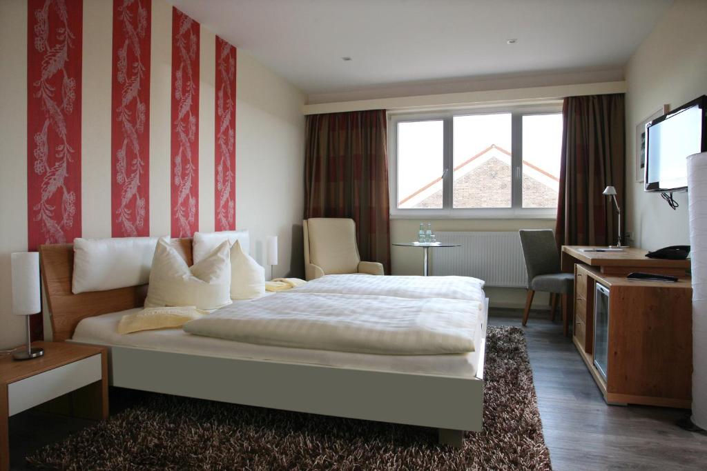 Postel nebo postele na pokoji v ubytování Hotel Rügenblick