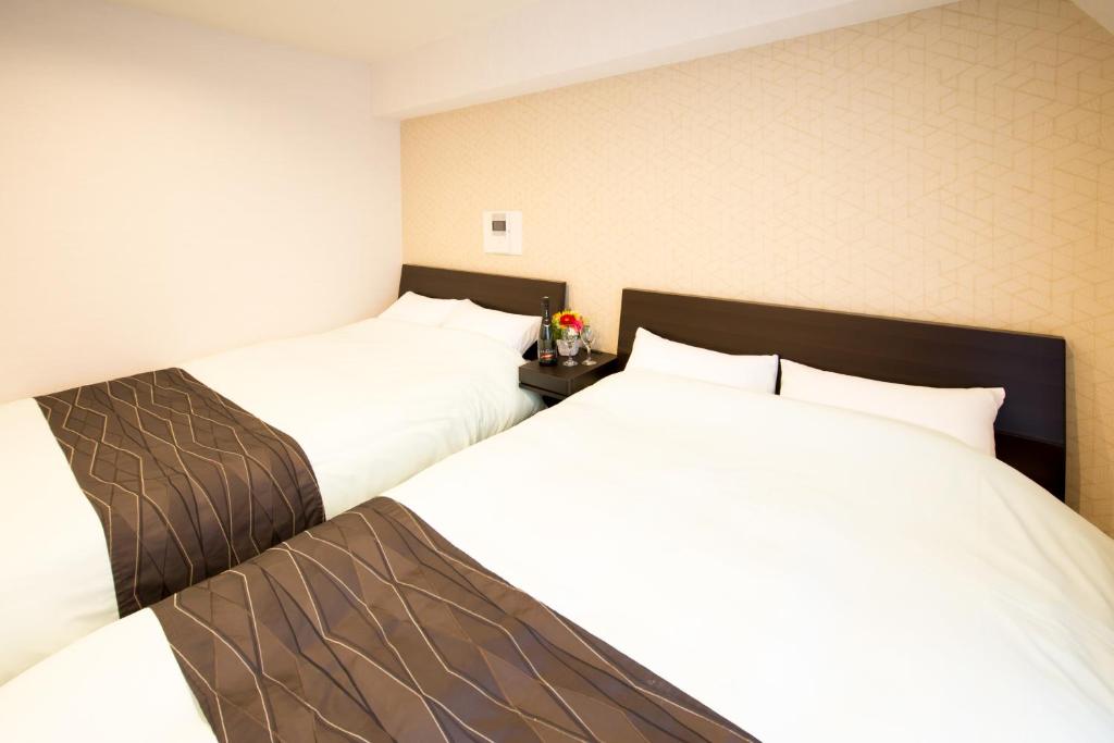 Postel nebo postele na pokoji v ubytování Hotel CoCoDe Plus