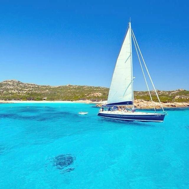 a sailboat in the water in a large body of water at Appartamenti Milù - Milù Holidays in La Maddalena