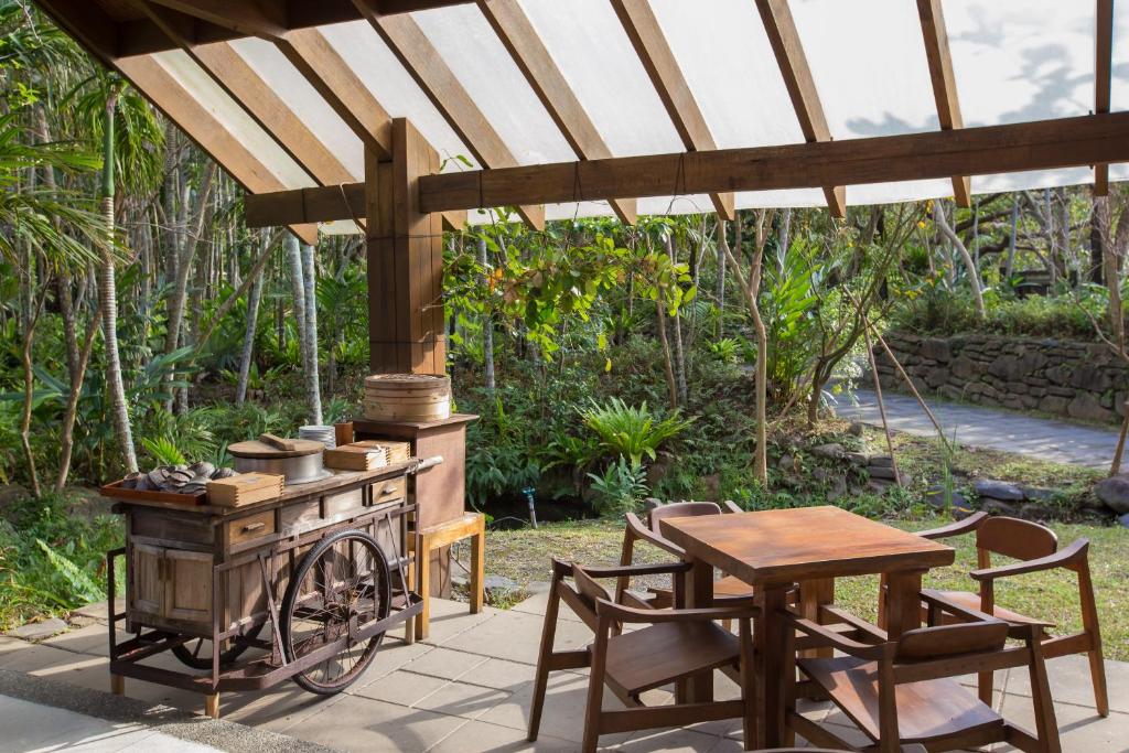 a outdoor kitchen with a wooden stove and a table at Mudanwan Villa in Mudan