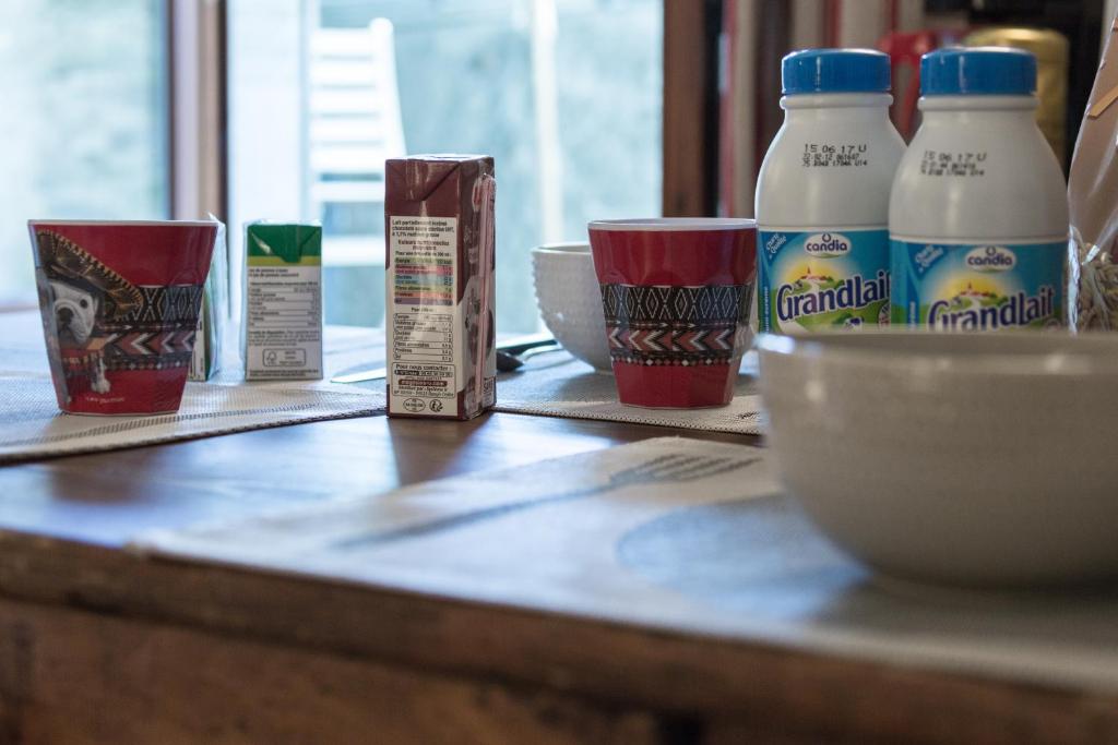 a counter with bottles of milk and cups on it at Bed end breakfast du centre in Bourg-Saint-Maurice