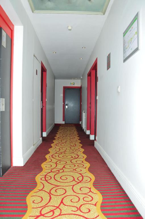 a hallway with red doors and a carpet at Cit&#39;Hotel Europeen in Angoulême