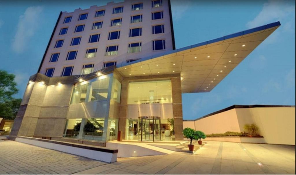 a large building with a large glass facade at The Pride Hotel, Bangalore in Bangalore