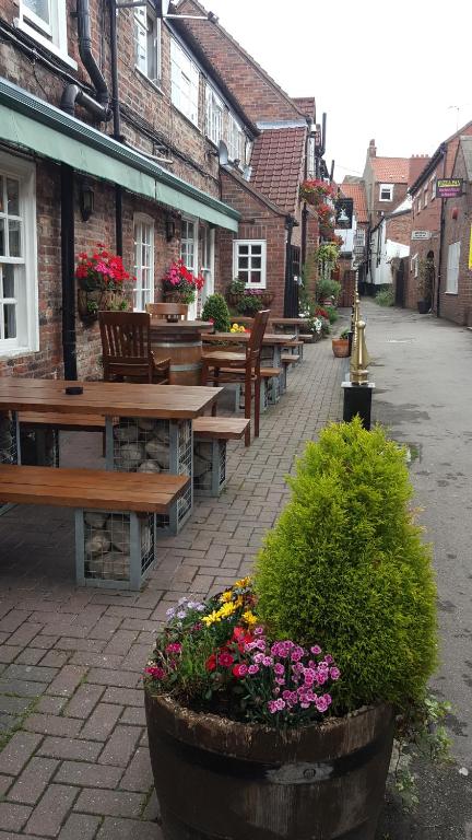 a row of benches and flowers on a street at Windmill Bed and Breakfast in Beverley