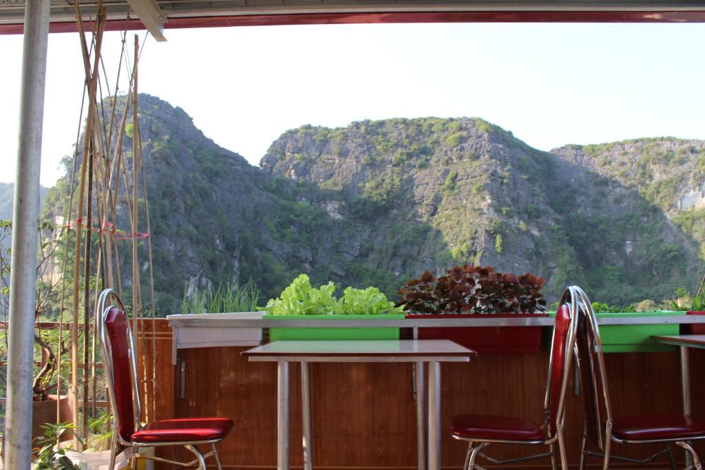 a table and chairs with a view of a mountain at Sierra Homestay in Ninh Binh