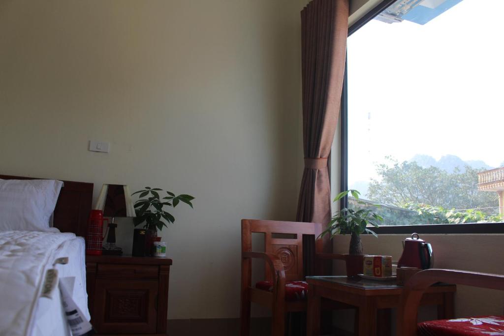 a bedroom with a bed and a window at Sierra Homestay in Ninh Binh