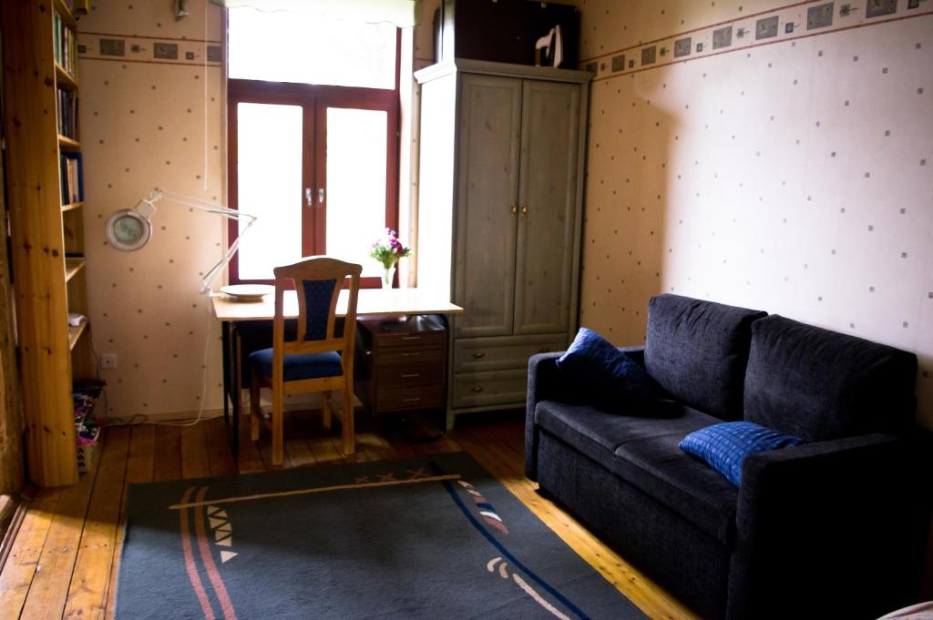 a living room with a couch and a desk at Salme Apartment in Tartu