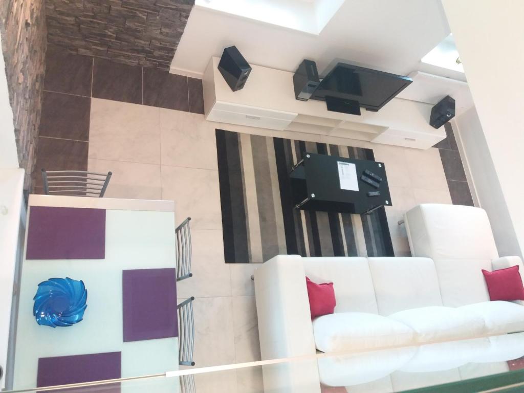 Televízia a/alebo spoločenská miestnosť v ubytovaní Apartment Osk