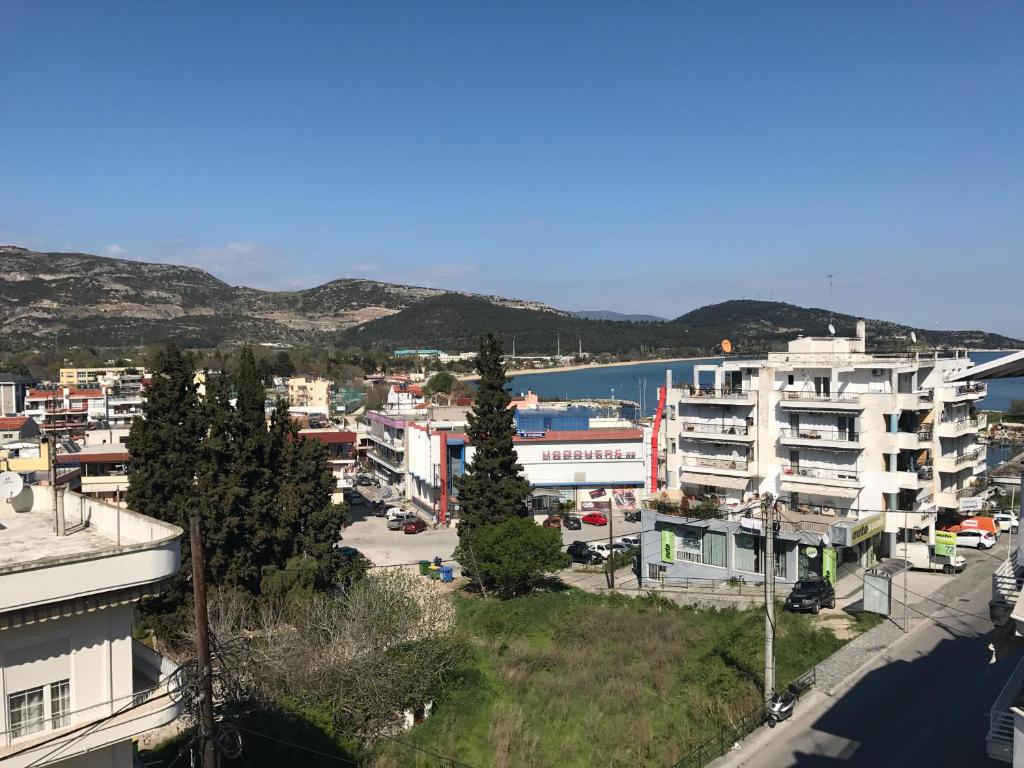 a city with buildings and a body of water at Family House in Kavala