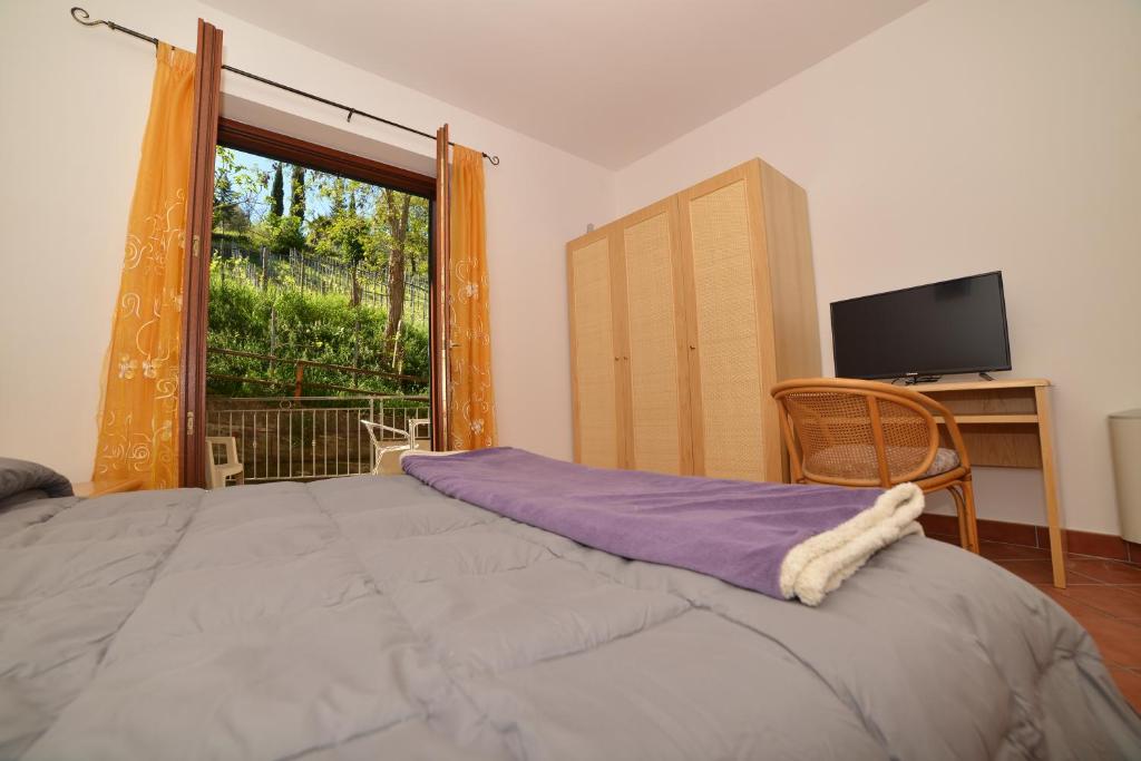 a bedroom with a large bed and a window at La Locanda di Campagna in Agropoli