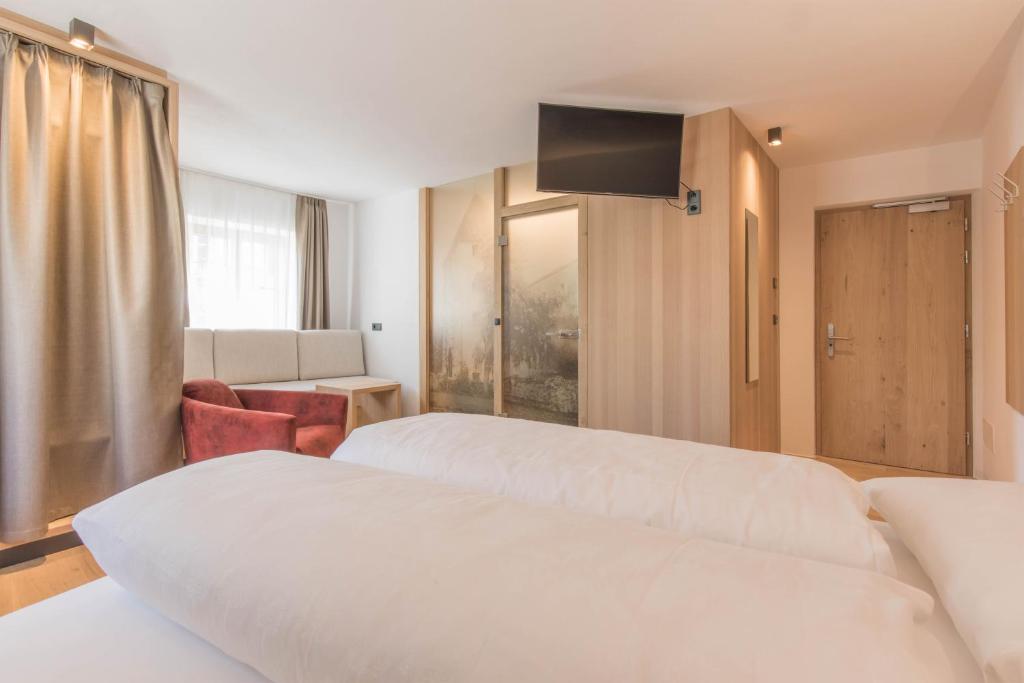 A bed or beds in a room at Belvenu Boutique Hotel