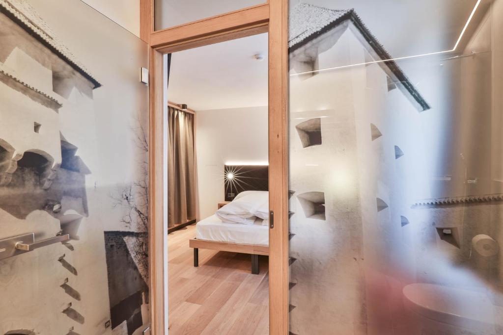A bed or beds in a room at Belvenu Boutique Hotel