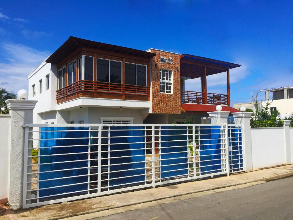 a house with a fence in front of it at Blue Acuarela in Cabrera