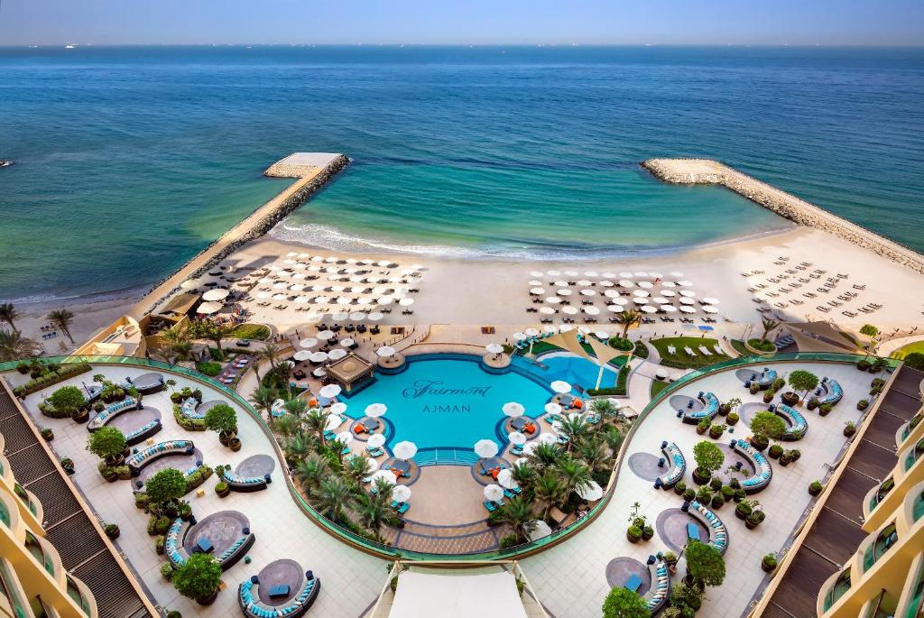 a beach filled with lots of colorful umbrellas at Fairmont Ajman in Ajman 
