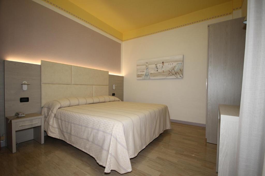 Postel nebo postele na pokoji v ubytování Hotel Grado