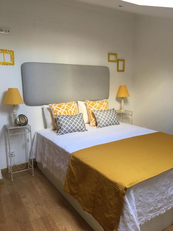 a large bed in a room with two lamps at Shabby Chic Bairro Alto 3 in Lisbon