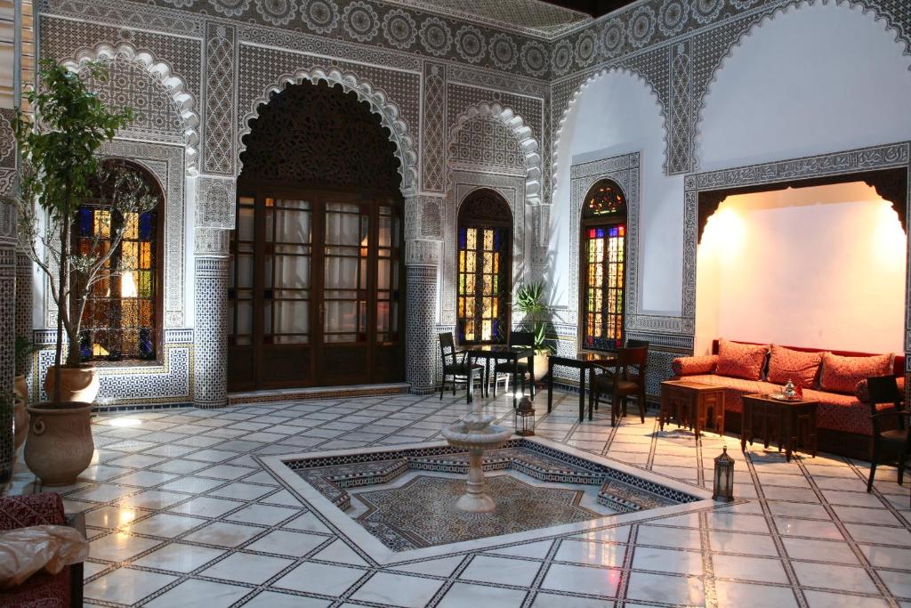a living room with a couch and a table at Riad Batchisarai in Fez