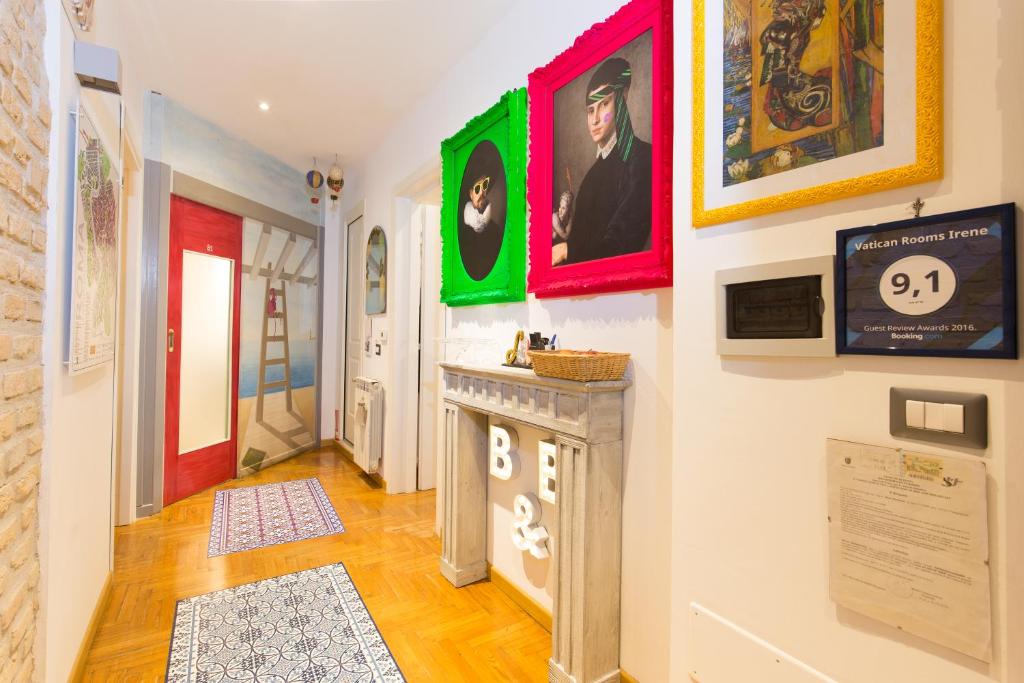 a hallway with paintings on the wall and a counter at Vatican Rooms Irene in Rome