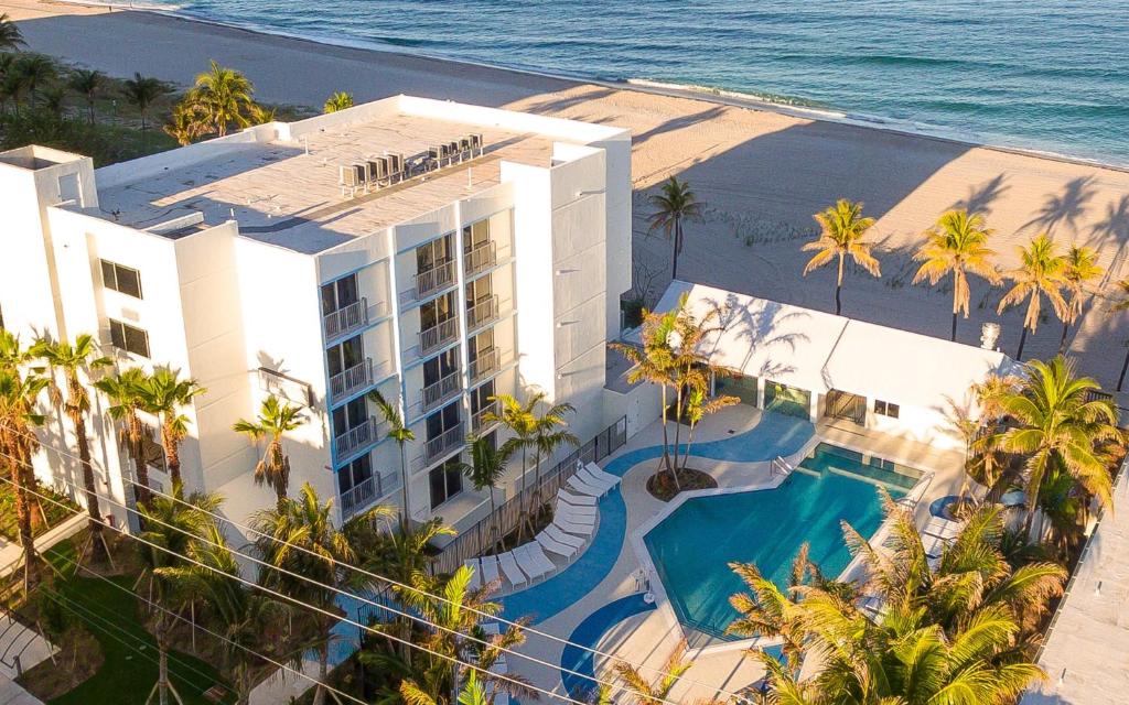 an aerial view of a resort with a swimming pool and the ocean at Plunge Beach Resort in Fort Lauderdale