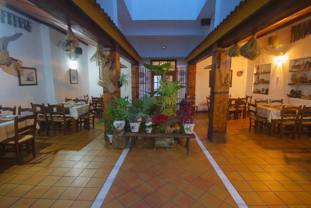 a restaurant with a table with plants on it at Hotel El Tabanco in El Bosque