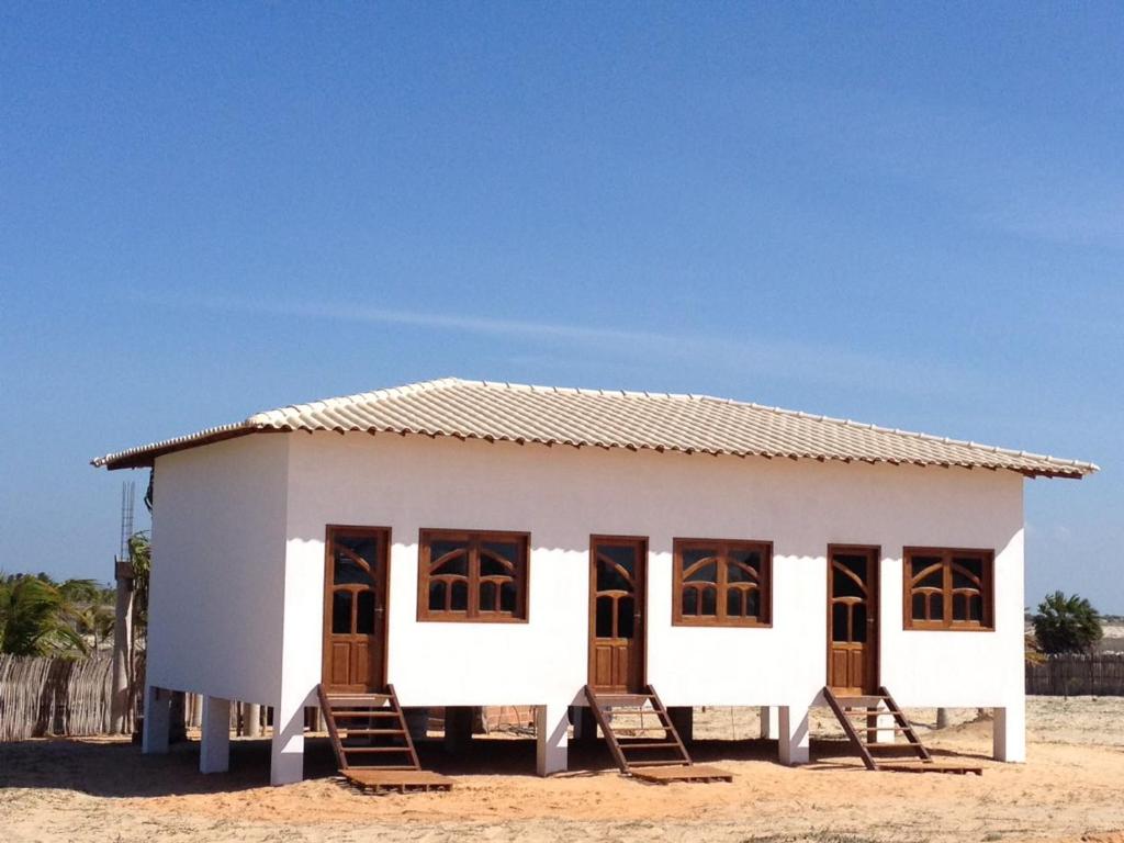 a small white house on the beach at Miss Penelope in Prea
