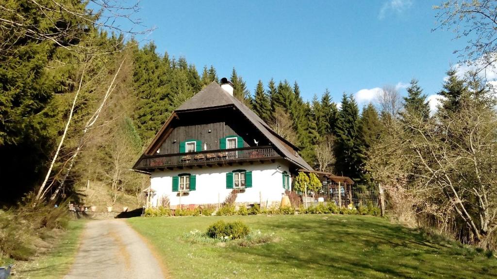 a house on top of a hill with a dirt road at Gästehaus Fridolin in Krieglach