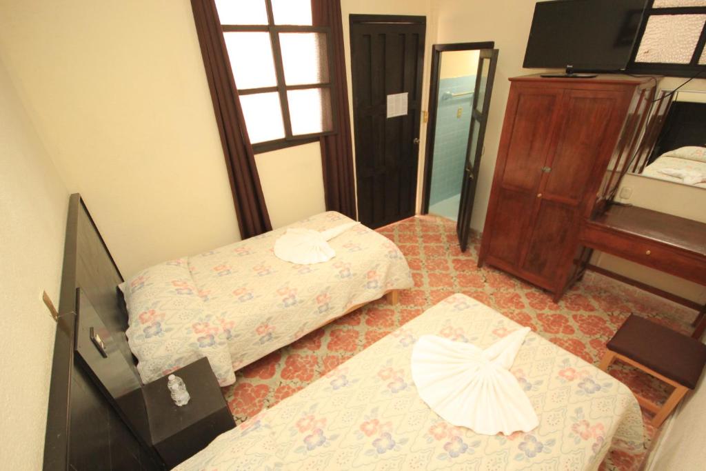 Postel nebo postele na pokoji v ubytování Hotel San Martin