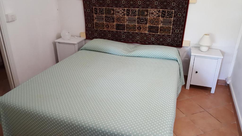a bed in a room with two night stands and two tables at La Vallata in Rovieto