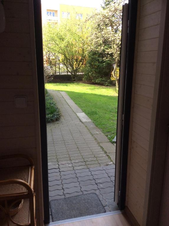 an open door to a patio with a grass yard at Apartment Garden in České Budějovice