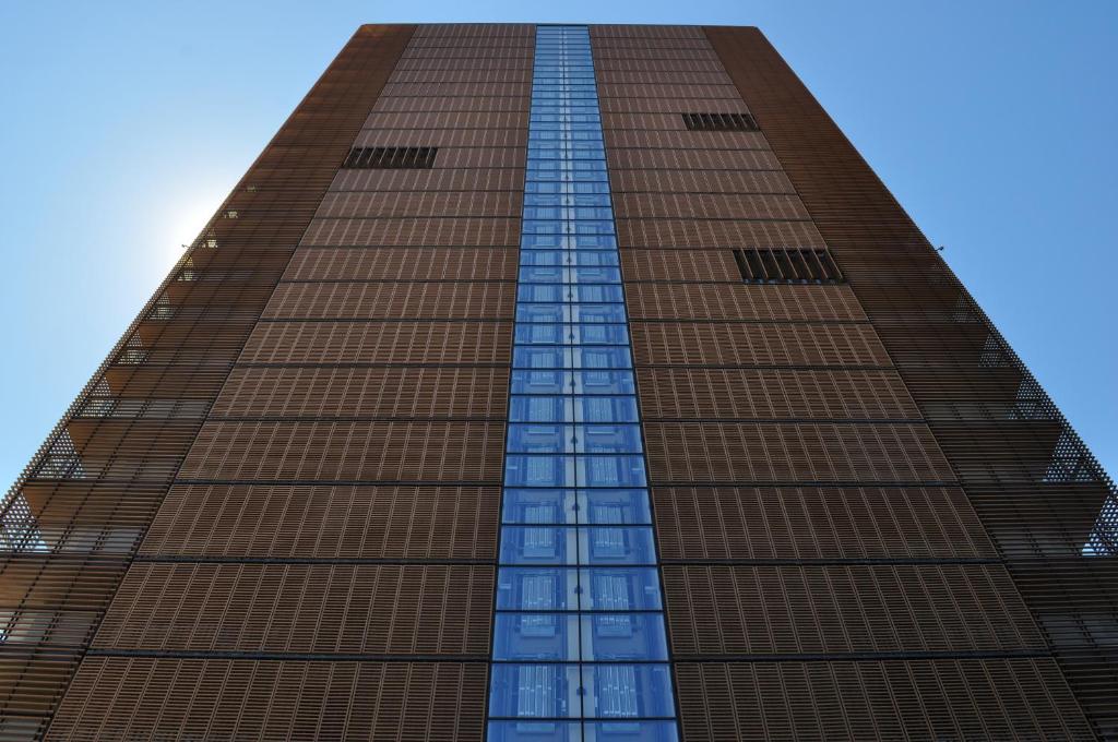 un edificio alto de color marrón con ventanas de cristal en Towerhousemilano, en Milán