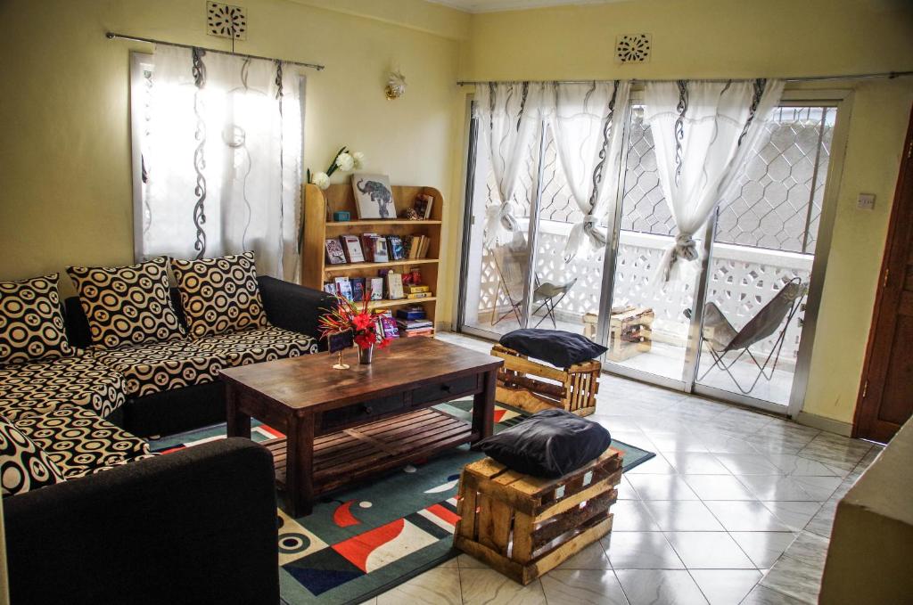 a living room with a couch and a coffee table at Wakawaka Hostel in Arusha