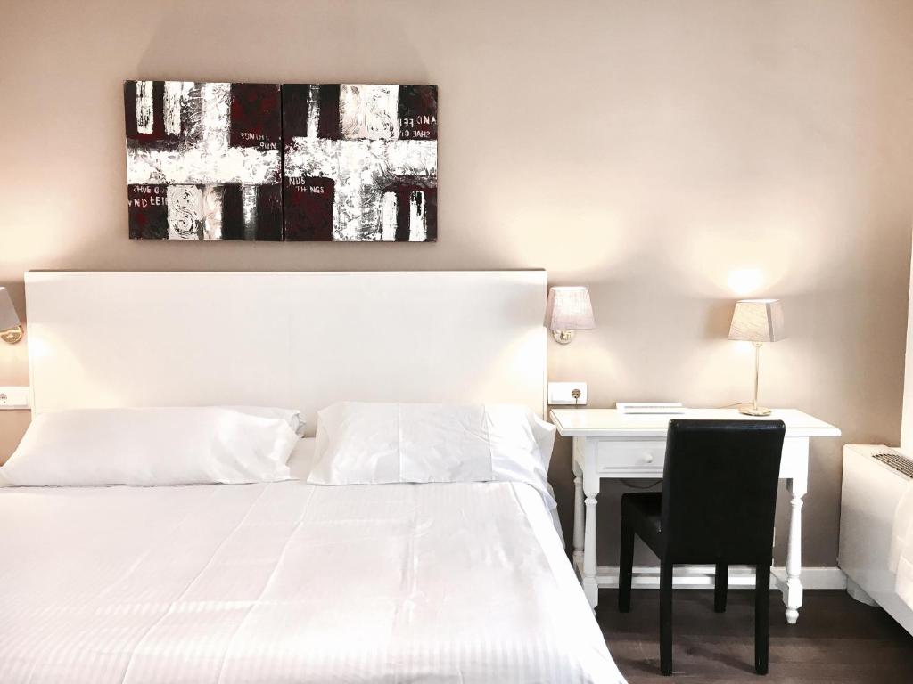 Postel nebo postele na pokoji v ubytování Hotel Carbonell