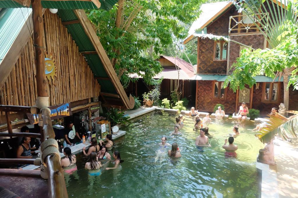 a group of people in a pool at a resort at Tropical Garden Bungalow in Phi Phi Don