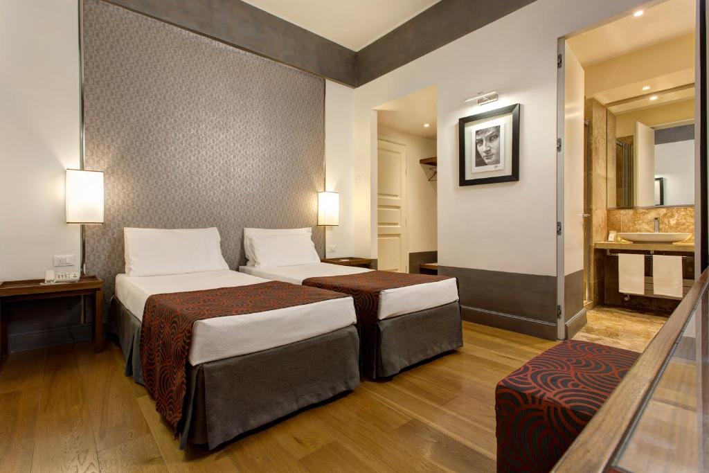 Postel nebo postele na pokoji v ubytování Hotel Orto de' Medici