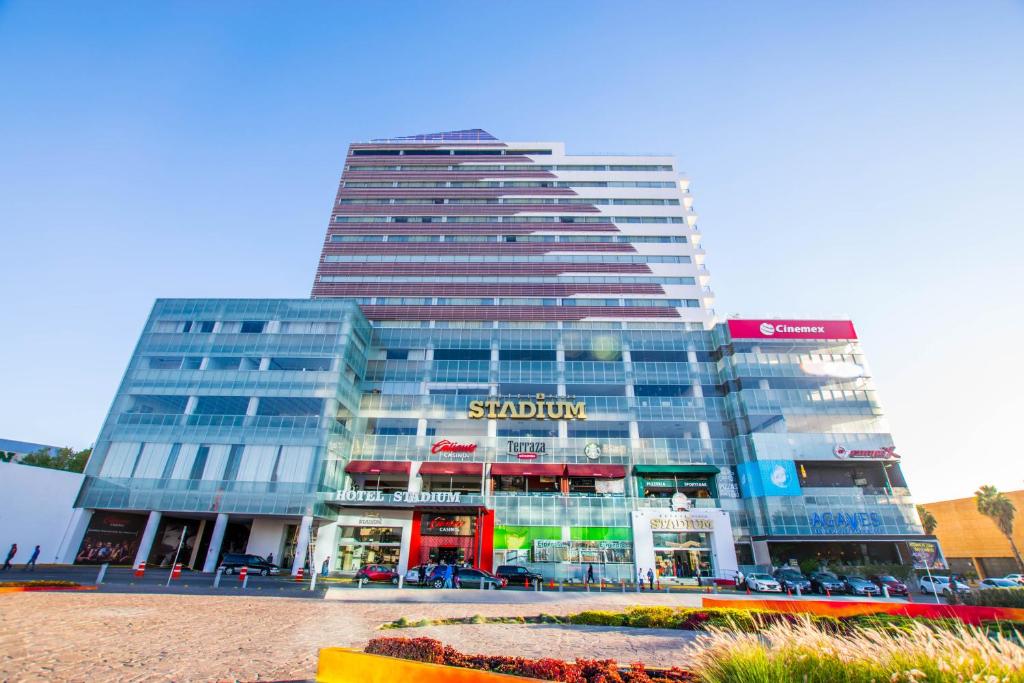 a tall building with a store in front of it at Hotel Stadium in León