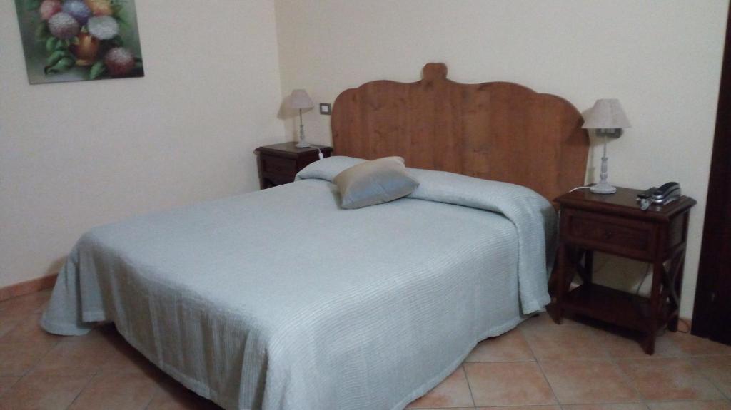 Postel nebo postele na pokoji v ubytování Residence Hotel La Commenda
