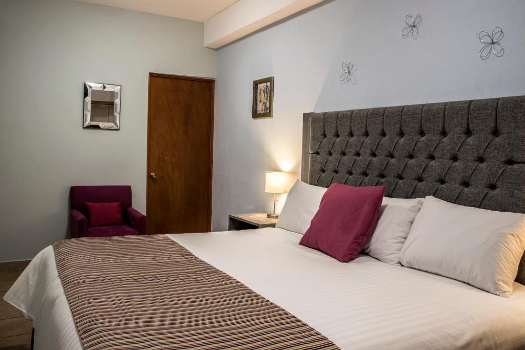 Postel nebo postele na pokoji v ubytování Hotel Casa Aurora
