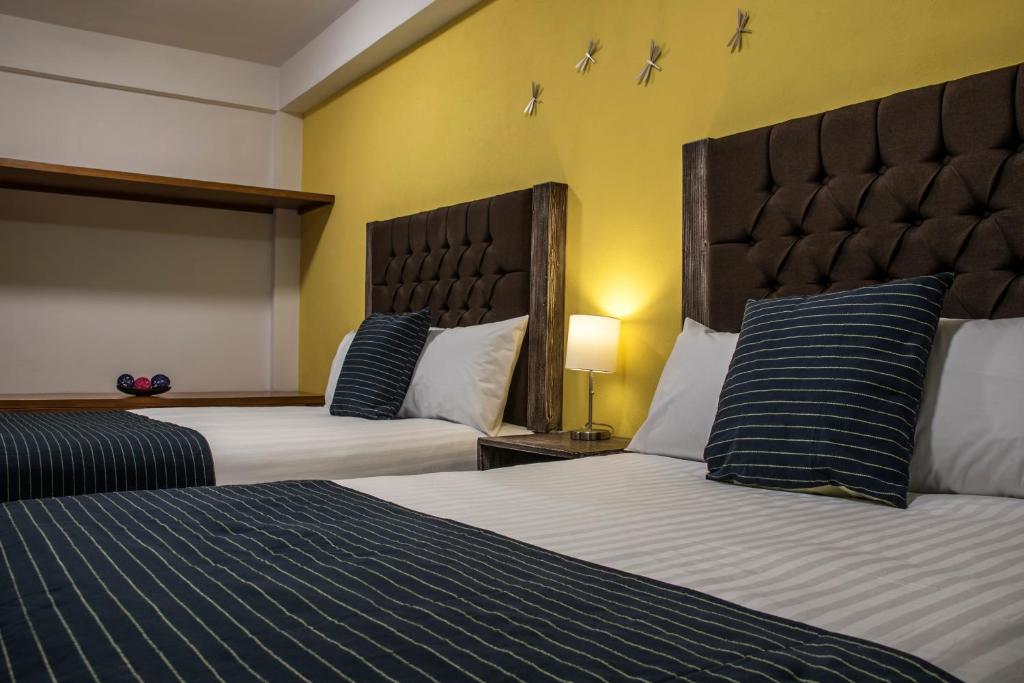 Postel nebo postele na pokoji v ubytování Hotel Casa Aurora